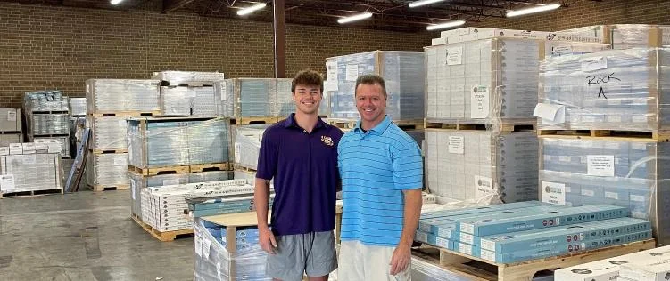 Chris Hartsell and CJ Hartsell, owners of Wholesale LVP Flooring, in their Cornelius, NC flooring warehouse